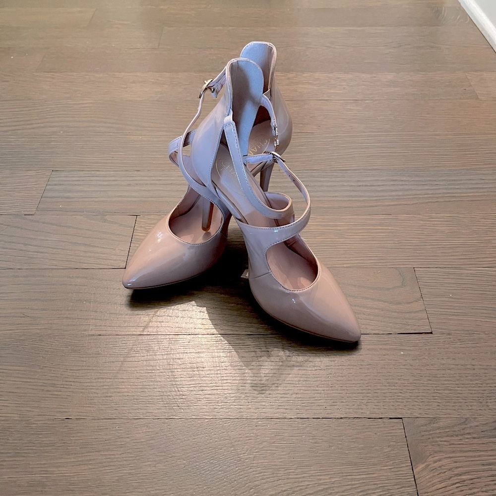 The shoes are size 7 and a half. The shoes have never been worn. They’re beige.